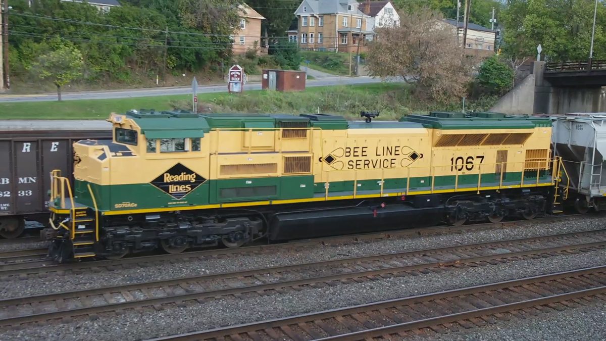 In this photo, Norfolk Southern's Electro Motor Diesels SD70ACe #1067 is in Norfolk Southern's Conway Yard. #1067 is painted in colors of the Reading Railroad. Which is now part of the Norfolk Southern Railroad System. In 2012, Norfolk Southern painted 20 General Electric (Wabtec) and Electro Motor Diesels engines in paint schemes of their predecessor railroads. These locomotives are known as "Heritage Units". #1067 is the Heritage Unit for the Reading Railroad.