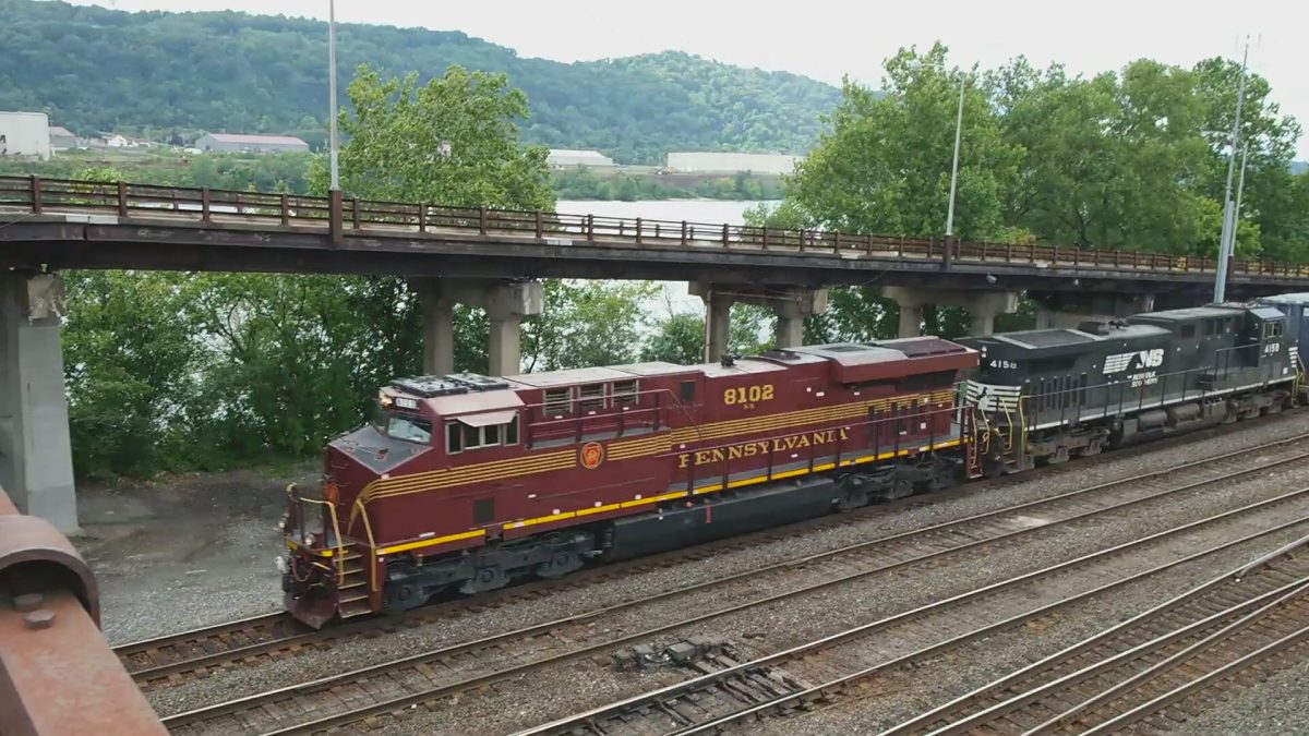 This photo is of Norfolk Southern's General Electric (Wabtec) ES44AC, numbered 8102. It is painted in the scheme of the Pennsylvania Railroad and is one of a collection of locomotives known as "Heritage Units". In this photo, the locomotive is leading a Garbage train out of Conway Yard, formerly owned by the Pennslyvania Railroad, in Baden, Pennsylvania.